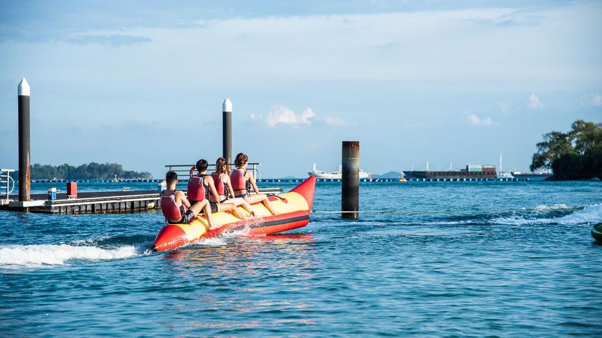 Group of friends riding on a banana boat