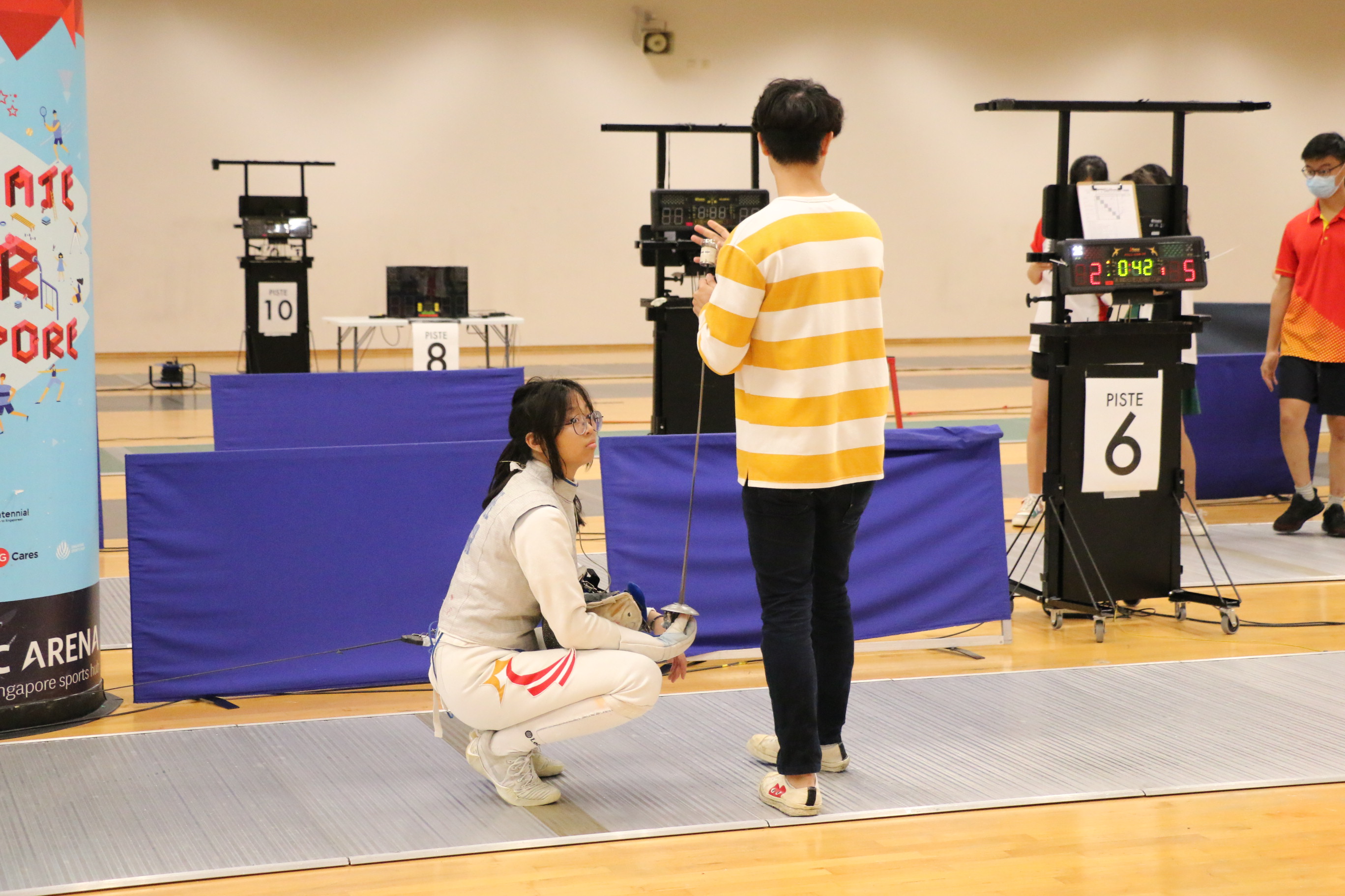 Lia Swee takes a breather in between her matches. Photo Credit : Team Nila Content Producer, Anbumani Arivalagan.