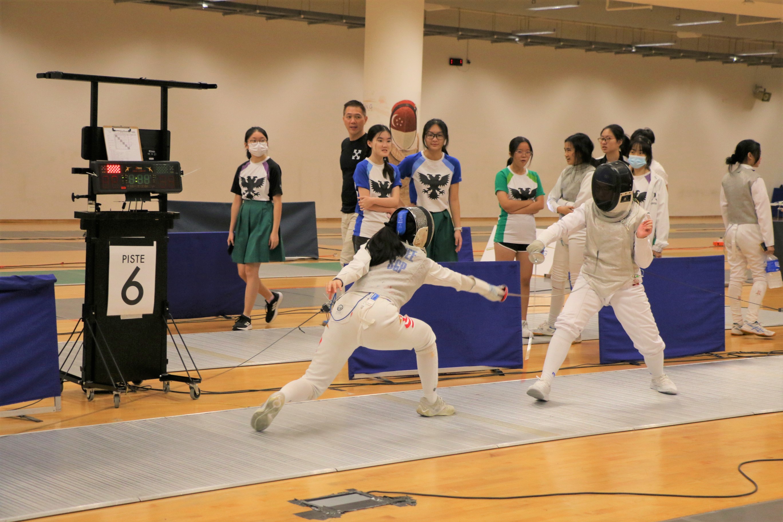 Top seed Lia Swee (Left) knocks out SAJC's Amelia Koh 15-3 in the Quarter-final stage of the Foil event.
