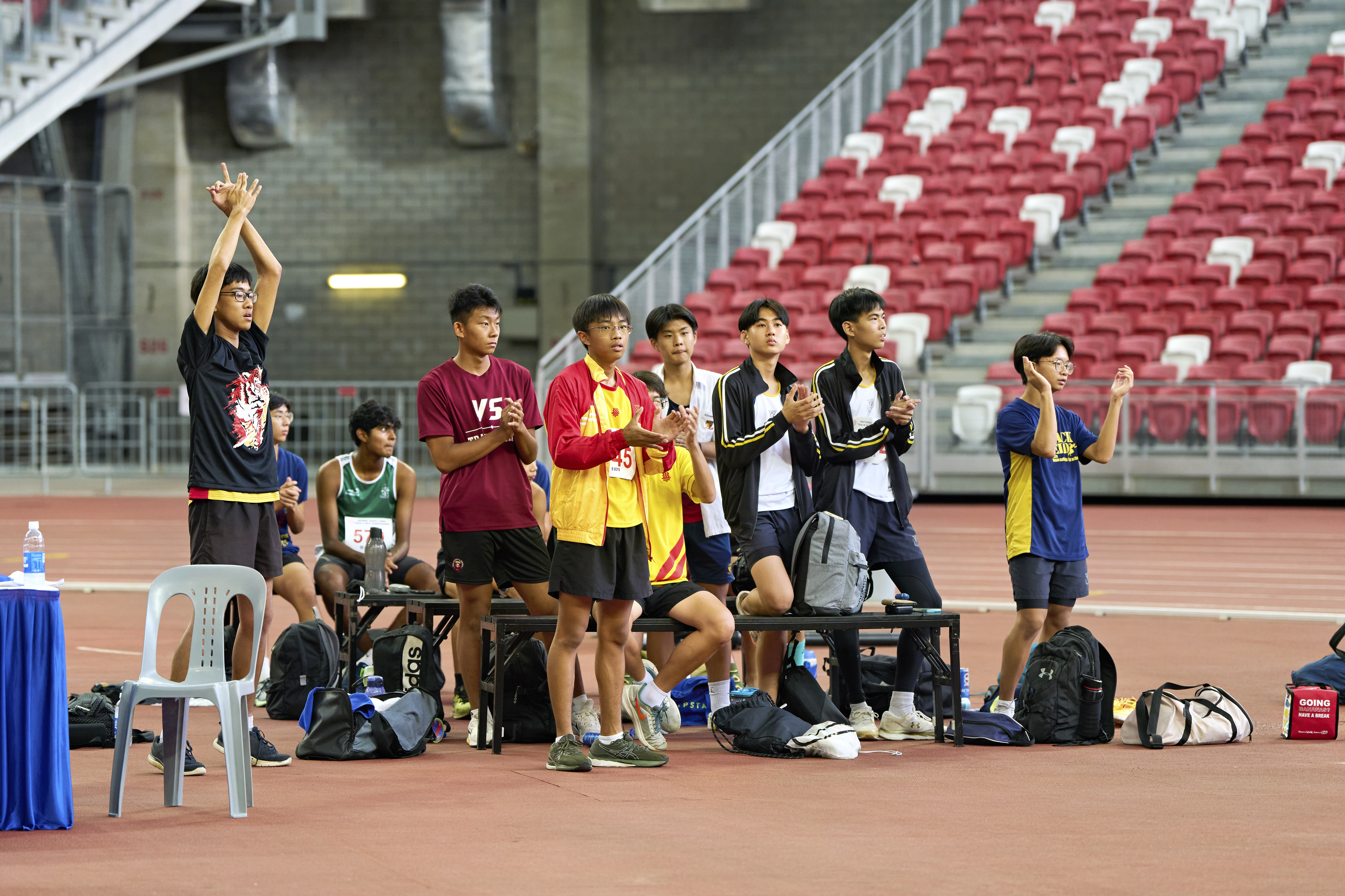 2023-04-28 NSG T&F Championships Photo by Eric Koh, Jumpers give encouragement to S Viresh Kumar(SPS) DSC07732