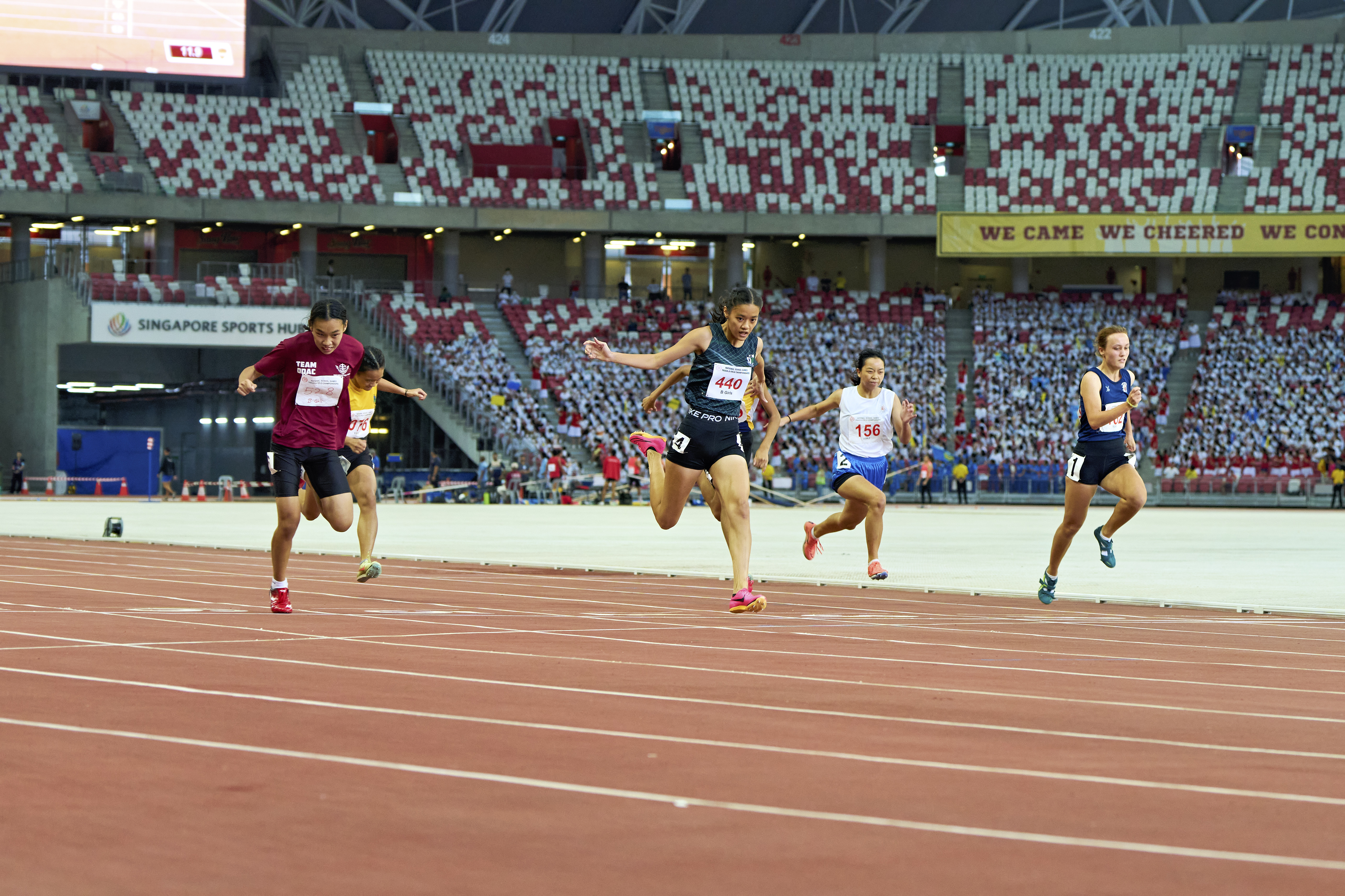 2023-04-28 NSG T&F Championships Photo by Eric Koh, Lim Yee Chern Clara (Bib no 440) finishes her race with a powerful run to claim the Gold medal  for B Div Girls 100m final DSC05798